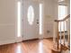 Foyer with hardwood floors, leaded glass front door, and stairway on the right at 5150 Rockford Ln, Stockbridge, GA 30281