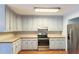 Traditional kitchen featuring a stainless steel refrigerator, wooden floors, and wooden countertops at 5150 Rockford Ln, Stockbridge, GA 30281