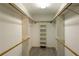 Walk-in closet with shelving and wooden hanging rods at 5150 Rockford Ln, Stockbridge, GA 30281