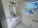 Modern bathroom features a vanity with a sleek black faucet, a framed mirror, and a window at 53 Springside Se Dr, Atlanta, GA 30354