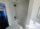 Updated bathroom showcasing a tub-shower with a tiled surround and black fixtures, next to a sink at 53 Springside Se Dr, Atlanta, GA 30354