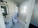 Renovated bathroom with white vanity, shower over tub, and modern fixtures at 53 Springside Se Dr, Atlanta, GA 30354