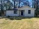 Charming single-story house featuring a painted brick facade and a well-maintained lawn at 53 Springside Se Dr, Atlanta, GA 30354