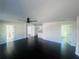 Bright living room featuring dark hardwood floors, neutral walls, and modern ceiling fan at 53 Springside Se Dr, Atlanta, GA 30354