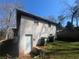 Backyard view featuring a back door and trash cans at 5744 Amalfi Way, Douglasville, GA 30135