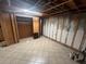 Unfinished basement showcases tile flooring, exposed ceiling with framework, and closet space at 5744 Amalfi Way, Douglasville, GA 30135