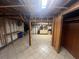 Unfinished basement area features tile flooring, exposed ceiling and wall studs, ready for customization at 5744 Amalfi Way, Douglasville, GA 30135