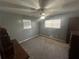 This bedroom has neutral walls, carpet, a ceiling fan, and natural light from two windows at 5744 Amalfi Way, Douglasville, GA 30135