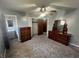 This bedroom has carpet, neutral walls, a ceiling fan, a closet, and bureaus for storage at 5744 Amalfi Way, Douglasville, GA 30135