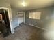 This bedroom features neutral walls, carpet, natural light, and a closet for storage at 5744 Amalfi Way, Douglasville, GA 30135