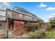 Back of house with a wooden deck, brick exterior, and stone steps leading up the landscaped yard at 816 Ivy Ridge Dr, Loganville, GA 30052