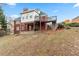 The backyard shows a multi-level deck, brick facade, and lush greenery at 816 Ivy Ridge Dr, Loganville, GA 30052