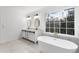 Elegant bathroom with freestanding tub, double vanity, and marble floors at 816 Ivy Ridge Dr, Loganville, GA 30052