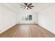 Serene bedroom featuring hardwood floors, tray ceilings, large windows, and neutral colors at 816 Ivy Ridge Dr, Loganville, GA 30052