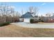 View of house showing yard and drive. House features a multi-car garage and mature trees in the surrounding area at 816 Ivy Ridge Dr, Loganville, GA 30052