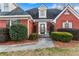 Charming red brick home with a beautifully landscaped front yard and an inviting glass-paneled front door at 816 Ivy Ridge Dr, Loganville, GA 30052