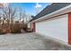 Attached multi-car garage, white doors, with a brick exterior and a view of the wooden deck at 816 Ivy Ridge Dr, Loganville, GA 30052