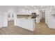 Updated white kitchen with stainless appliances, an island, and an open view to other rooms at 816 Ivy Ridge Dr, Loganville, GA 30052