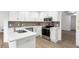 Modern kitchen with white cabinets, quartz countertops, stainless steel appliances, and hardwood floors at 816 Ivy Ridge Dr, Loganville, GA 30052