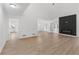 Open-concept living room featuring hardwood floors, neutral walls, a black fireplace, and multiple windows and doors at 816 Ivy Ridge Dr, Loganville, GA 30052