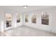 Sun-drenched sun room features tile flooring and backyard access at 816 Ivy Ridge Dr, Loganville, GA 30052