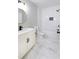 Modern bathroom featuring marble floors, white subway tile shower and black fixtures at 2143 Lyle Ave, College Park, GA 30337