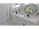A bathroom boasting a double vanity, stylish lighting, and modern black fixtures against a marble countertop at 2143 Lyle Ave, College Park, GA 30337