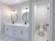 A double sink bathroom vanity featuring modern black fixtures, lighting, and a separate toilet room at 2143 Lyle Ave, College Park, GA 30337