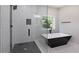 Stylish bathroom showcases a black and white tub, glass shower, and modern fixtures for relaxation at 2143 Lyle Ave, College Park, GA 30337