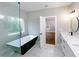 Modern bathroom boasts a sleek tub, double vanity, and glass shower for a spa-like experience at 2143 Lyle Ave, College Park, GA 30337