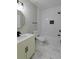Modern bathroom featuring marble floors, white subway tile shower and black fixtures at 2143 Lyle Ave, College Park, GA 30337