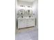 Elegant bathroom featuring a double vanity with gold framed mirrors, and modern fixtures at 2143 Lyle Ave, College Park, GA 30337