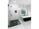 Modern bathroom with a glass shower enclosure, black herringbone tile, and a luxurious soaking tub at 2143 Lyle Ave, College Park, GA 30337