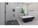 Modern bathroom features a sleek glass shower and soaking tub at 2143 Lyle Ave, College Park, GA 30337