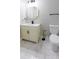 Well-lit bathroom featuring marble floors, toilet and vanity with black fixtures at 2143 Lyle Ave, College Park, GA 30337