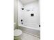 Bright bathroom features white subway tile, black fixtures, and a window at 2143 Lyle Ave, College Park, GA 30337