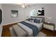 Comfortable bedroom with a cozy bed, stylish linens, ceiling fan, and natural light from a window at 2143 Lyle Ave, College Park, GA 30337