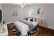 Bright bedroom featuring a large bed with colorful linens, a modern TV and a zebra rug at 2143 Lyle Ave, College Park, GA 30337