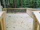 Unstained wood deck with wooden railings overlooks a lush, green, wooded backyard at 2143 Lyle Ave, College Park, GA 30337