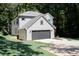 Side view of a charming two-story home with a gray front-facing garage at 2143 Lyle Ave, College Park, GA 30337