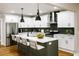 Beautiful kitchen with white cabinets, a center island, a breakfast bar, and sleek stainless steel appliances at 2143 Lyle Ave, College Park, GA 30337