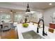 Bright, airy kitchen featuring modern fixtures, stainless steel sink, and an open view of living spaces at 2143 Lyle Ave, College Park, GA 30337