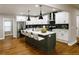 Elegant kitchen with white cabinets, large island with seating, stainless steel appliances, and open layout at 2143 Lyle Ave, College Park, GA 30337