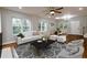 Bright living room with hardwood floors, a cozy seating area, and a view of the dining space at 2143 Lyle Ave, College Park, GA 30337