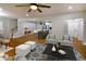 Open living area featuring hardwood floors, a modern kitchen, and comfortable seating at 2143 Lyle Ave, College Park, GA 30337