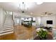 Open-concept living room with hardwood floors, modern furnishings, and an adjacent kitchen area at 2143 Lyle Ave, College Park, GA 30337