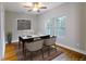 Home office showcasing a sleek black desk, chairs, and hardwood floors bathed in natural light at 2143 Lyle Ave, College Park, GA 30337