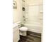 Bathroom featuring a shower and tub with white cabinets and dark wood flooring at 2633 Coventry Sw St, Atlanta, GA 30331