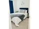 Cozy bedroom features carpet, a navy headboard, and soft gray accent pillows at 2633 Coventry Sw St, Atlanta, GA 30331