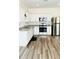 Bright kitchen features stainless steel appliances, granite counters, and hardwood floors at 2633 Coventry Sw St, Atlanta, GA 30331